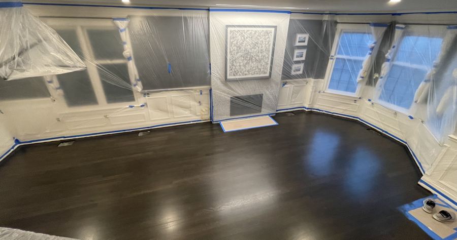 Room fully wrapped and taped for dust protection during refinishing