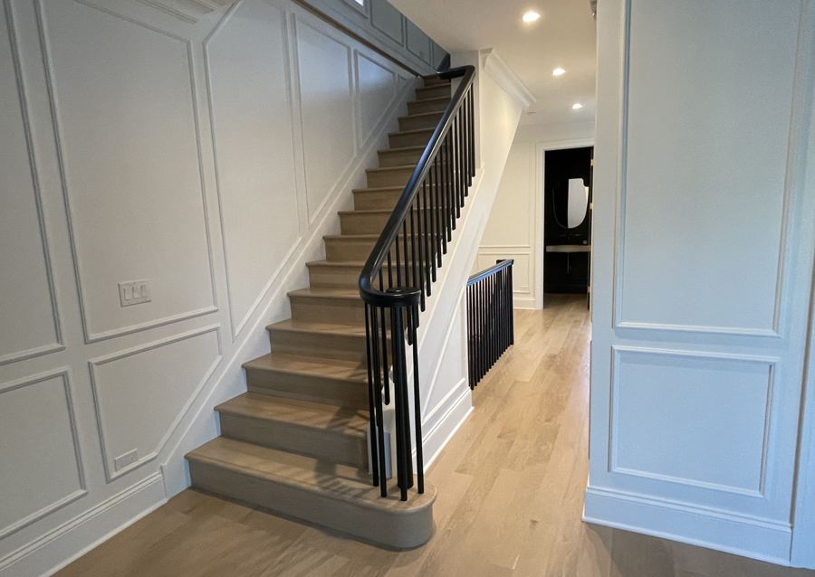 Custom hardwood staircase built and finished to match the floors in a Chicago home